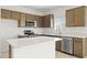 Modern kitchen with wood cabinets, island, and stainless steel appliances at 24003 W Mohave St, Buckeye, AZ 85326