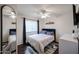 Bedroom with wood floors, a ceiling fan, and a large mirror at 2135 S Bristol --, Mesa, AZ 85209