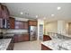 Kitchen with wood cabinets, granite countertops and stainless steel appliances at 21853 N 261St Ave, Buckeye, AZ 85396