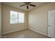 Well-lit bedroom featuring tile flooring and ceiling fan at 21853 N 261St Ave, Buckeye, AZ 85396