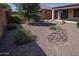 Landscaped backyard with gravel, rock features, and desert plants at 21853 N 261St Ave, Buckeye, AZ 85396
