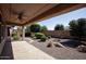 Covered patio with ceiling fan and desert landscaping at 21853 N 261St Ave, Buckeye, AZ 85396