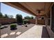 Covered patio with ceiling fan and desert landscaping at 21853 N 261St Ave, Buckeye, AZ 85396