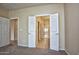Bedroom with double doors to bathroom and carpet at 21853 N 261St Ave, Buckeye, AZ 85396