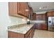 Modern kitchen with granite countertops and stainless steel appliances at 21853 N 261St Ave, Buckeye, AZ 85396