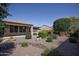 Back exterior view of house with desert landscaping at 21853 N 261St Ave, Buckeye, AZ 85396