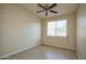 Bright bedroom with ceiling fan and tile floor at 21853 N 261St Ave, Buckeye, AZ 85396