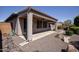 Back exterior view of house with covered patio and desert landscaping at 21853 N 261St Ave, Buckeye, AZ 85396