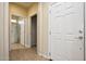 Clean hallway with tile flooring and access to rooms at 21853 N 261St Ave, Buckeye, AZ 85396