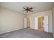 Large bedroom with double doors leading to bathroom at 21853 N 261St Ave, Buckeye, AZ 85396