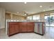 Kitchen island with granite countertop and stainless steel dishwasher at 21853 N 261St Ave, Buckeye, AZ 85396