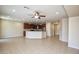 Open living room with tile floors and a ceiling fan at 21853 N 261St Ave, Buckeye, AZ 85396