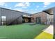 Modern backyard oasis with artificial turf and fire pit at 8509 S 10Th Ln # 23, Phoenix, AZ 85041