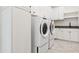 Bright laundry room with white cabinets and a modern sink at 8509 S 10Th Ln # 23, Phoenix, AZ 85041