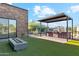 Outdoor kitchen with a built-in grill and pergola at 8509 S 10Th Ln # 23, Phoenix, AZ 85041