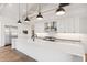 Modern kitchen with white cabinets, stainless steel appliances, and a large island at 8509 S 10Th Ln # 23, Phoenix, AZ 85041