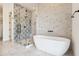 Spa-like bathroom with a freestanding tub and patterned tile at 8509 S 10Th Ln # 23, Phoenix, AZ 85041