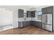 Stylish bar area with dark gray cabinets and stainless steel appliances at 8509 S 10Th Ln # 23, Phoenix, AZ 85041