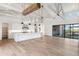 Modern kitchen with white cabinets, large island, and exposed beams at 8509 S 10Th Ln # 23, Phoenix, AZ 85041