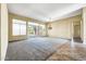 Bright living room with tile and carpet flooring, large windows, and a chandelier at 8196 E Sunnyside Dr, Scottsdale, AZ 85260