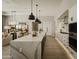 Modern kitchen with a large island, white cabinets and a marble countertop at 5755 S Joshua Tree Ln, Gilbert, AZ 85298