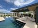 Luxury pool with spacious patio, seating, and a covered structure at 5755 S Joshua Tree Ln, Gilbert, AZ 85298