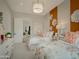 Charming bedroom with two twin beds and orange accent wall at 5755 S Joshua Tree Ln, Gilbert, AZ 85298