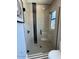Modern shower with glass enclosure and black tile detail at 5755 S Joshua Tree Ln, Gilbert, AZ 85298