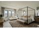 Spacious main bedroom with a large four-poster bed and plenty of natural light at 5755 S Joshua Tree Ln, Gilbert, AZ 85298