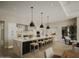 Modern kitchen with a large island, marble countertops, and stylish pendant lighting at 5755 S Joshua Tree Ln, Gilbert, AZ 85298