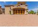 Grand three-car garage with wood doors and paver driveway at 6215 E Turquoise Ave, Paradise Valley, AZ 85253