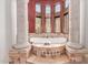 Soaking tub with columns, and large windows at 6215 E Turquoise Ave, Paradise Valley, AZ 85253