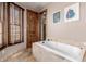 Relaxing bathroom with soaking tub and large windows at 6215 E Turquoise Ave, Paradise Valley, AZ 85253