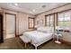 Comfortable bedroom with ensuite bathroom access and large windows at 6215 E Turquoise Ave, Paradise Valley, AZ 85253
