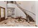 Elegant entryway with a curved staircase and tile flooring at 6215 E Turquoise Ave, Paradise Valley, AZ 85253