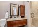 Bathroom with granite countertop, wooden vanity, and shower at 6215 E Turquoise Ave, Paradise Valley, AZ 85253