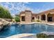 Large pool with spa and rock waterfall feature at 6215 E Turquoise Ave, Paradise Valley, AZ 85253