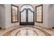 Elegant entryway with ornate double doors and tile floor at 6215 E Turquoise Ave, Paradise Valley, AZ 85253