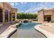 Resort-style pool with waterfall feature and spacious patio at 6215 E Turquoise Ave, Paradise Valley, AZ 85253
