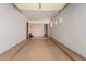 Tan colored two-car garage with a high ceiling and neutral walls at 6215 E Turquoise Ave, Paradise Valley, AZ 85253