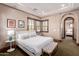 Bright bedroom with a queen-size bed and ensuite access at 6215 E Turquoise Ave, Paradise Valley, AZ 85253