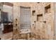 Large walk-in shower with multiple shower heads and glass block feature at 6215 E Turquoise Ave, Paradise Valley, AZ 85253