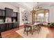 Elegant dining room with large windows and a rustic wooden table at 6215 E Turquoise Ave, Paradise Valley, AZ 85253