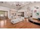 Open living room showcasing a sectional sofa, hardwood floors and access to the kitchen at 6215 E Turquoise Ave, Paradise Valley, AZ 85253