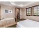 Bedroom with a queen-size bed and access to a soaking tub at 6215 E Turquoise Ave, Paradise Valley, AZ 85253