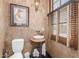 Small bathroom with a pedestal sink and toilet at 6215 E Turquoise Ave, Paradise Valley, AZ 85253