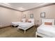 Bedroom with three twin beds and neutral decor at 6215 E Turquoise Ave, Paradise Valley, AZ 85253