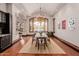 Bright dining room with hardwood floors, a rustic dining table, and a large window at 6215 E Turquoise Ave, Paradise Valley, AZ 85253