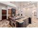 Island kitchen with granite countertop and professional-grade range at 6215 E Turquoise Ave, Paradise Valley, AZ 85253