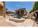 Private spa with adjacent pool and waterfall at 6215 E Turquoise Ave, Paradise Valley, AZ 85253
